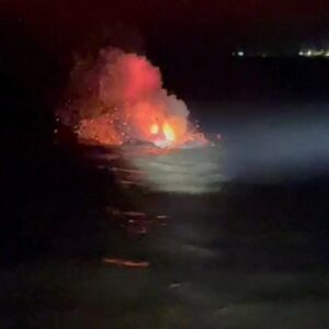 Flares aid rescue of two people from burning boat